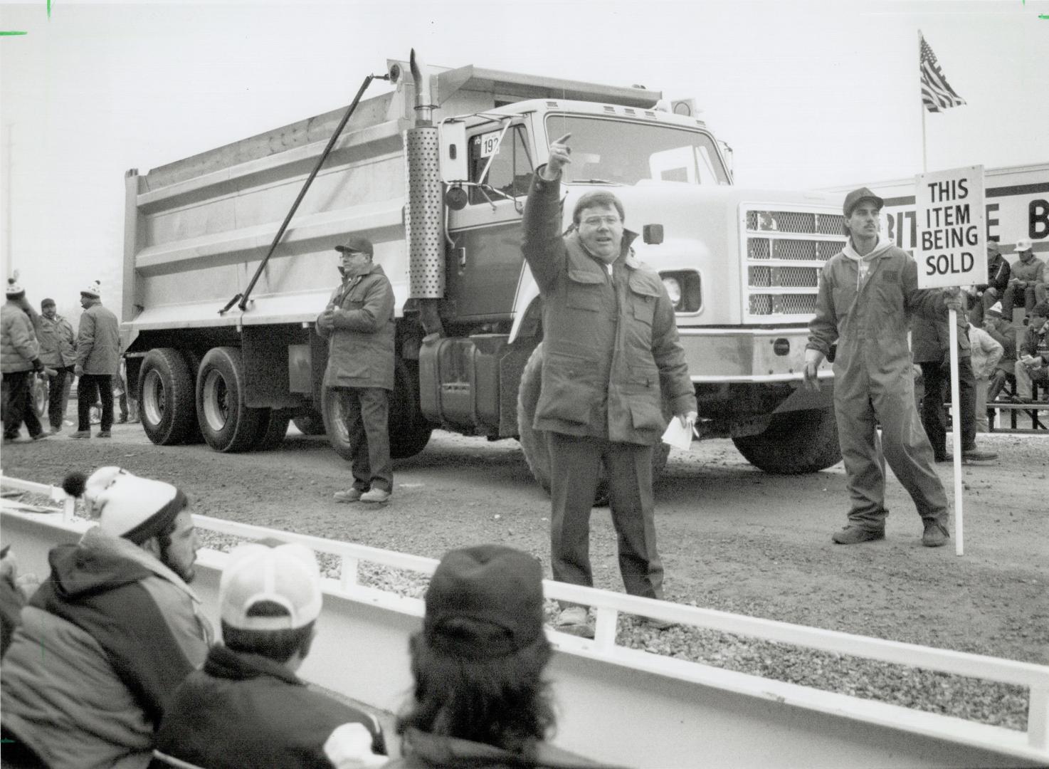 Seeking bids. Dave Sharp works to heat up the bidding on a dump truck at an auction sale held yesterday by Ritchie Bros. Auctioneers, in Bolton. It wa(...)