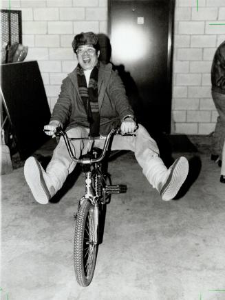 Low-cost transportation. Ching Chen, 40, tries out a bicycle he bought yesterdat for a mere $15 at the Metro Toronto police auction of unclaimed goods(...)