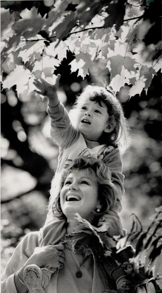 Indian summer harvest. Three-year-old Melissa Reichert Kilbey and her mother, Barbara, take advantage of the sunshine and yesterday's high of 22C (72F(...)