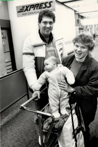 Happy landing: The Air Canada shutdown ended just in time for Craig, Helen and Justin Noble, 4 months, formerly of Toronto but now of Vancouverm, who arrived to visit family for Christmas