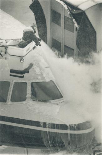 White Mischief: Carlo Luchetta, left, de-ices a Mexicanbound L-1011 loaded with snowbirds at Pearson airport yesterday while David Roeder digs out Broadview Ave