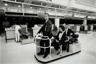 Pearson airport's glitzy new $421 million Trillium Terminal, above, appears open for business yesterday as actors play the role of airline employees a(...)