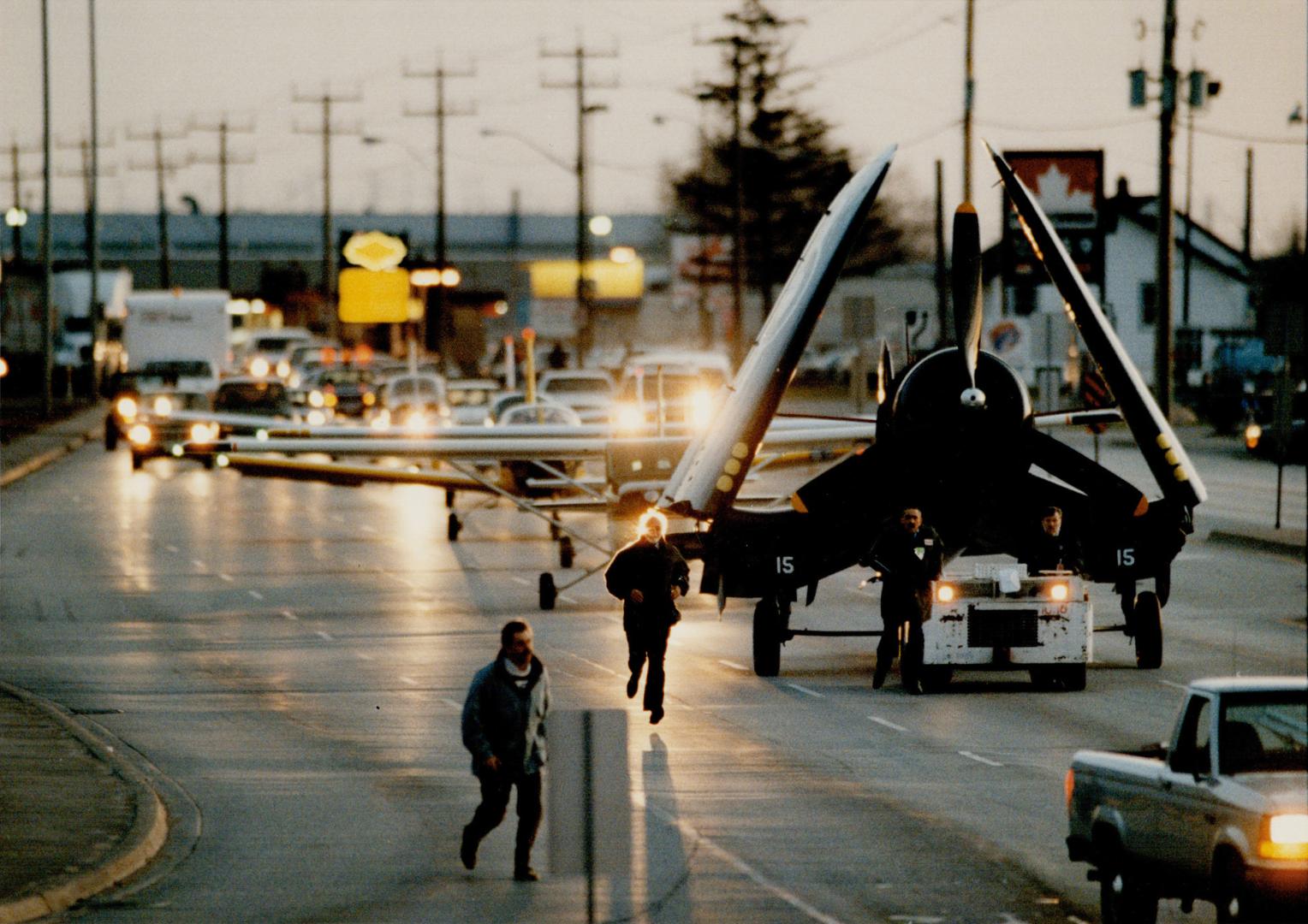 A world war II navy Corsair, on loan from the War Heritage Museum, leads six aircraft along Derry Rd