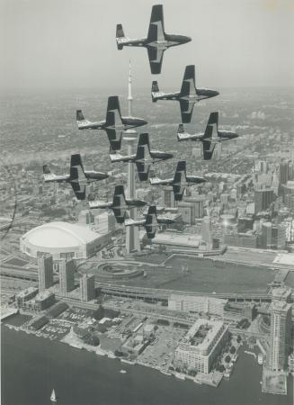 Snowbirds warm up: A Star photographer, flying with a pilot outside the nine-plane formation, snaps the world-famous stunt team in perfect synch during a media preview yesterday