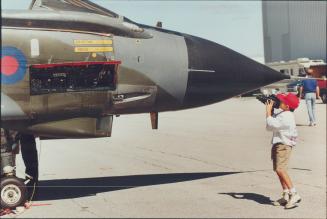 Arthur Avila, 8, zooms in for a real closeup of an RAF Torondo at the CNE air show yesterday