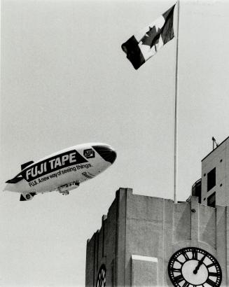 Sky-high promotion. Tourists and Torontonians saw the latest advertising method on the waterfront yesterday as the Fuji blimp hovers over the Queen's (...)