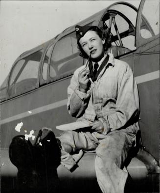 On the wing of plane Pte. Ingrid Wemberg finds time to write a letter. Women are recruited from Norwegian girls and R.N.A.F. fliers' wives