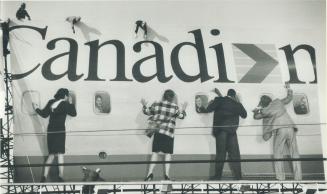 High-flying antics. Workers finish installing a billboard for Canadian Airlines yesterday along the Gardiner Expressway west of Strachan Ave. and appe(...)