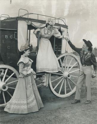 Jack Turnbull helps passengers, Carolyn Oshanek, left, and Marcia Marks from stage coach