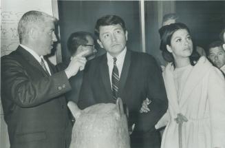 Guided tour of the Indians of Canada pavilion is given John Belindo (centre), director of the U