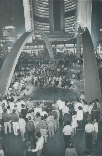 Snake dance swingers wind their way through the pool in front of new City Hall as the Centennial revelry reached its heigt last night. And talking of (...)