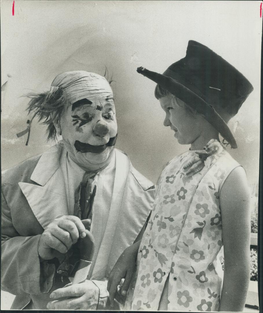 Clowning around with one of the 93,500 visitors on the opening day yesterday of the Canadian National Exhibtion, Fifi the clown lends his topper to 8-(...)