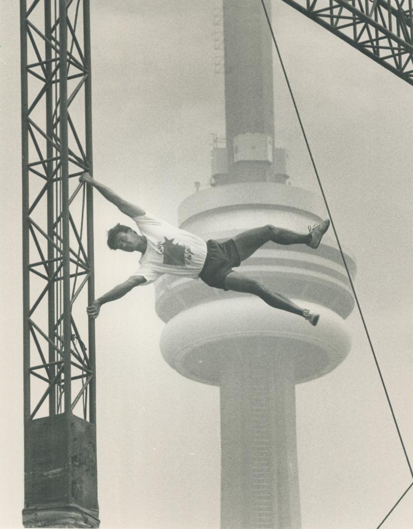 With the CN Tower in the background, acrobat Alain Gauthier of Quebec-based Cirque du Soleil performs on the main mast of the big top. The one-ring ci(...)