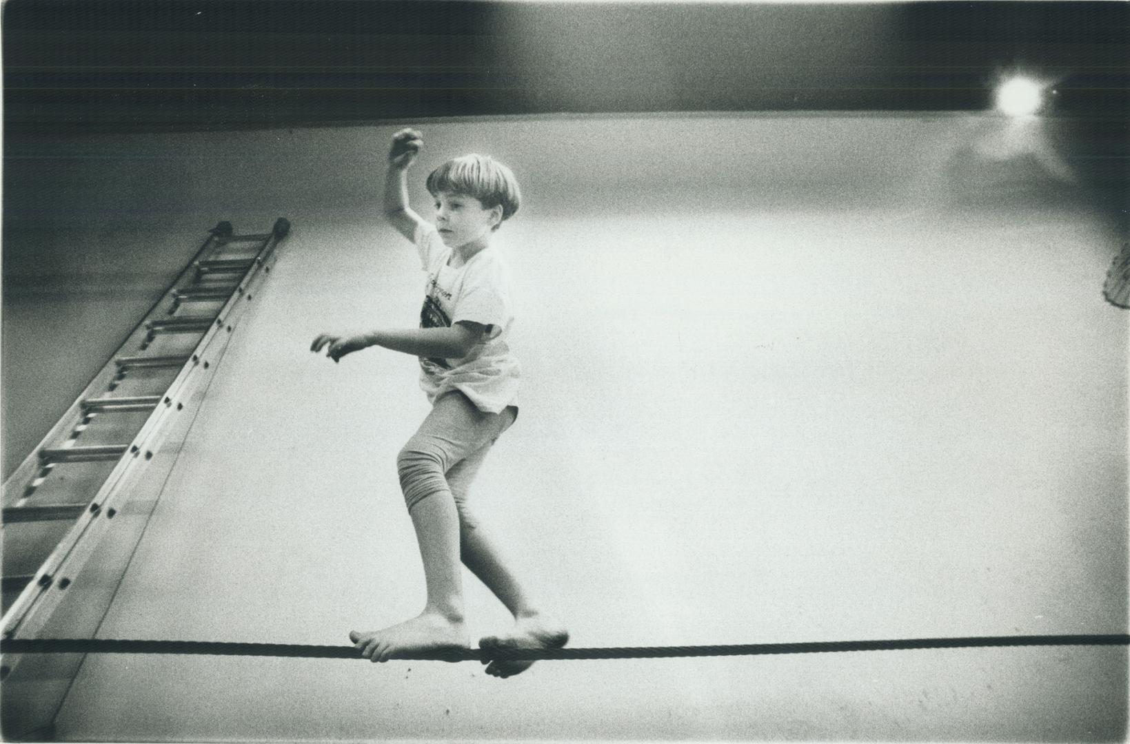 Caleb Cooper, 8, balances on the high wire