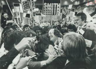 and is hugged by wife Paddy at the moment of victory on the convention floor yesterday