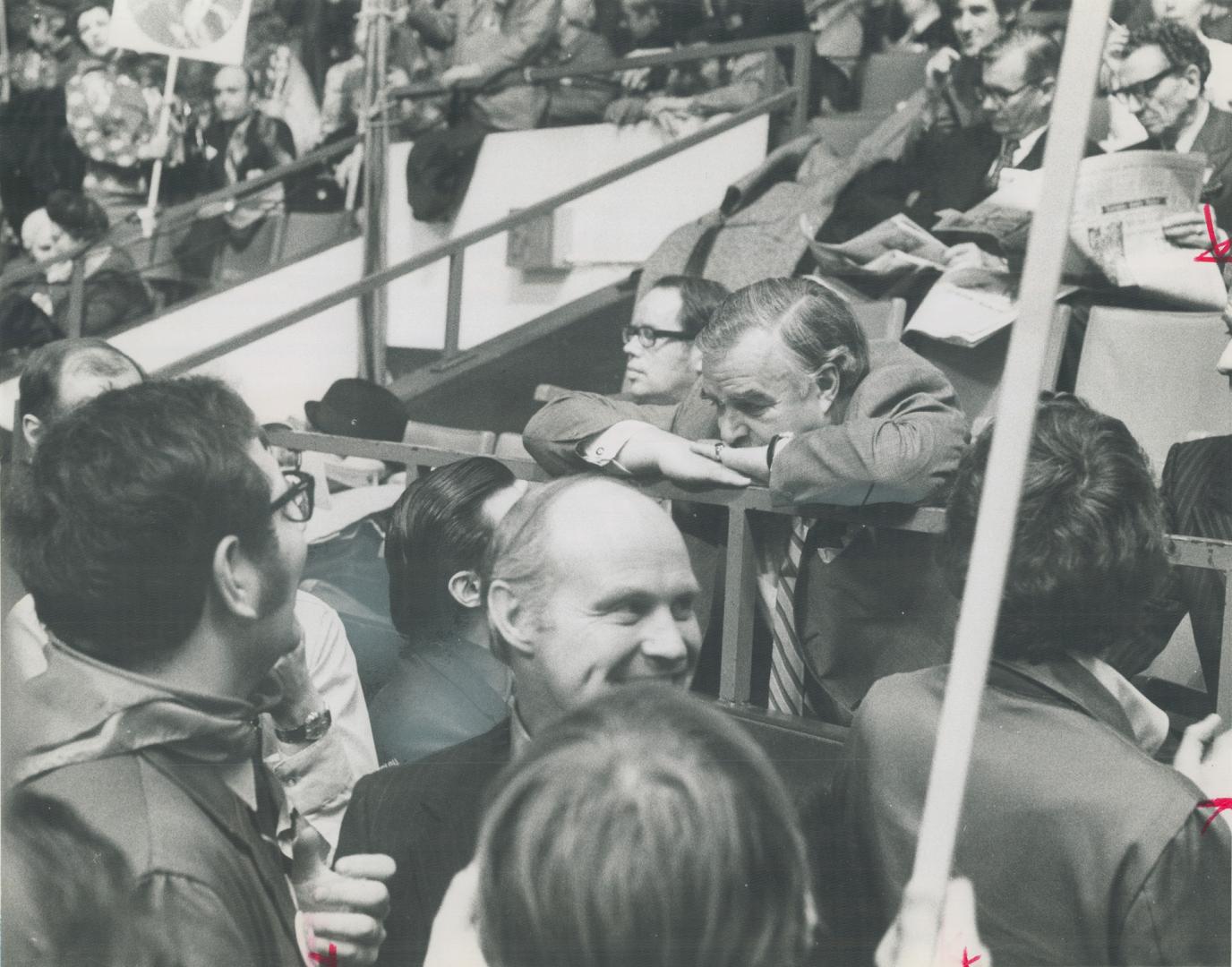 On the sidelines now, head resting on his folded arms (at centre), retiring Ontario Premier John Robarts listens to hurricane sound around him as dele(...)