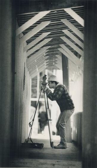 A Stalemate: James Strand, an engineer's assistant, works on a construction project while talks between 80,000 Ontario construction workers and their employers go on