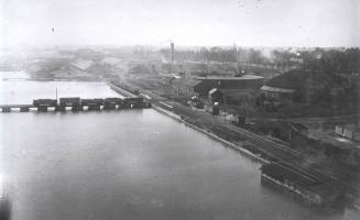 Image shows an aerial view of the lake and some waterfront buildings.