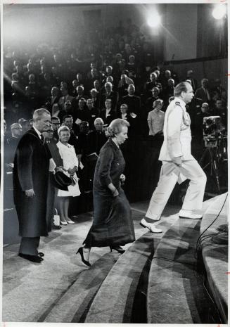 Aide De Camp Cmdr. J. W. F. Goodchild leads Mrs. Michener and Provost Moffat Woodside of the U. of T. onto platform for opening of Theology of Renewal(...)