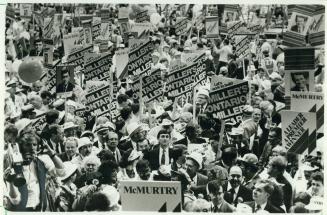 Early in the afternoon, the convention floor is awash in a sea of signs as delegates do their utmost to make their man appear the most popular