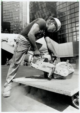 Mike Hayes was hard at it last week to repair the sidewalk in front of the Royal Bank Plaza on Front St. West in downtown Toronto