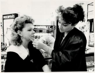 Perfect match: Prescriptives consultant Vilma Carpignano, right, employs the color printing technique on customer Susan Wellington to determine the correct color of foundation for her