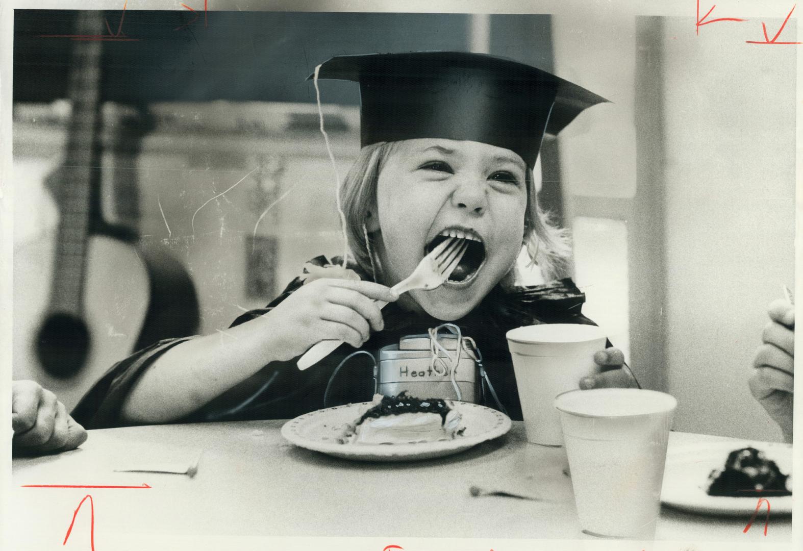 Eat 'em up. Kindergarden graduation for 5-year-old Heather Nichols means apricot cake and a tough road ahead. She and nine other deaf youngsters donne(...)