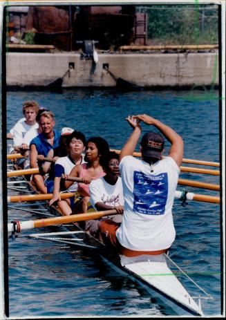 Team Effort: Garth Nichols signs tips to deaf children at the Bayside Rowing Camp yesterday