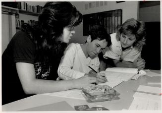 Going to school: Roxann Cook, right, program co-ordinator at Beat The Street, helps two students