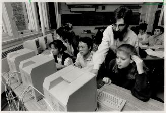 Electronic authors: From left, students Grace low, John Tran, Claire Mason, with teacher Trevor Owen behind Mason