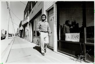 Liberal Hopes: Hair stylist Mario Veneziano passes vacant store on O'Connor Dr. He's betting on Jean Chretien to put Canadians back to work