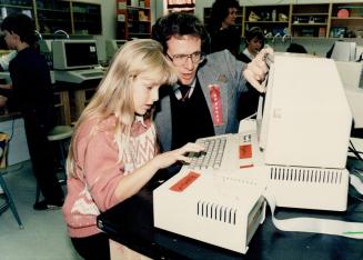 Computer class, Rachael Shrive, 11, is assisted by teacher Bill Peel at the second annual computer fair at Sir Alexander Mackenzie Public School last week