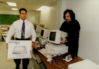 Taking them away: Joe Campana, left and Sam Pollari repossess computers from the Labourers' International Union of North America, Local 183, yesterday