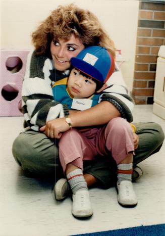 Students study parenting in high school, Matthew Wong, 4, gets a big hug from Brampton Centennial Secondary School student Shannon Langton