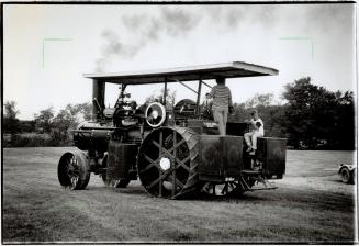 Oldtimer: David Stirk gives his son Iain, 8, a ride aboard his 1919 Sawyer Massey steam engine