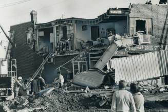 Violent Gas Explosion today blew out this 35-foot by 10-foot section of the brick apartment wall above Crayden's Pharmacy on Bloor St., in Etobicoke, (...)