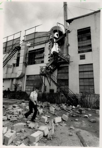 Unglued: Concrete blocks litter the yard outside a glue factory where an explosion blew out a wall yesterday