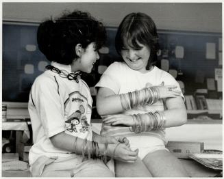 Hot Items: Amber Prowse-Zwegers, 9, left, and Cindy Lee, 11, are typical of sutdents at Gledhill Public School and other Metro schools - they just can't get enough of rubber bracelets