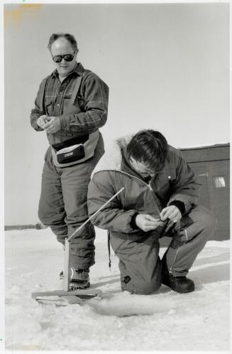 Frosty fishermen: Kevin Cunningham wets a line while Steve Warren gets ready to join him