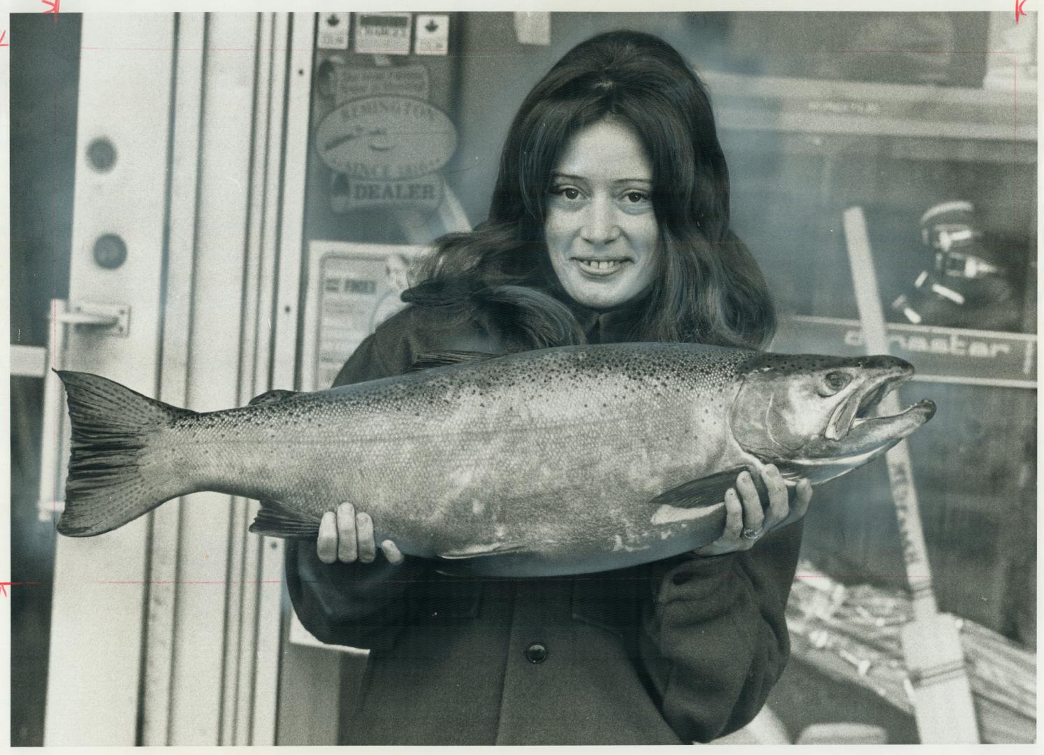 A rainbow of happiness. Noreen Cavan, 24-year-old Scarborough resident displays a rainbow trout weighing 13.15 pounds which she recently caught in the Sydenham River at Owen Sound. [Incomplete]