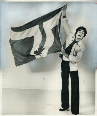 The official flag of the City of Toronto, chosen yesterday from among 670 entries, is waved by Renato De Santis, the graphic arts student who designed(...)