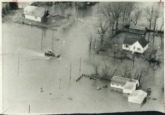 Floodwater rises steadily higher in Carman, one of the small Manitoba communities unprotected by dikes