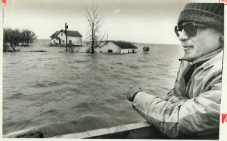 Flood worker surveys choppy waters of Red River as wind whipped across prairie adding to stricken residents' fears