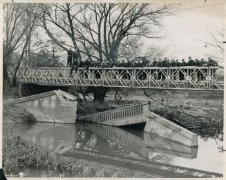 First municipally owned bridge to be replaced since Friday night's destructive floods has been erected over the Don river on John St., Thornhill. [Incomplete]