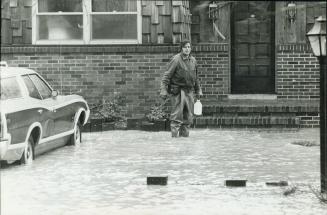 The milk must go through, Flood or no flood this conciencious milkman in St