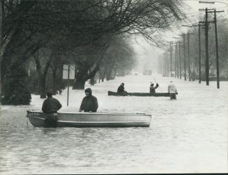 Searching for residents in flood, Rescuers, walk through waters sometimes reaching three feet on the main street of St