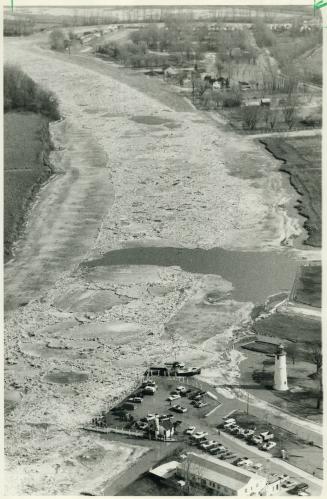 Swollen river: Residents watching the tugboats manoeuvre had to leave in a hurry when the river overflowed its banks, leaving much of the area under a foot of water