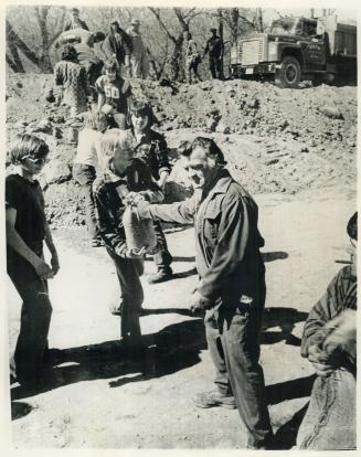 4. A line of volunteers are placing sandbags on of the weaker parts of the dikes