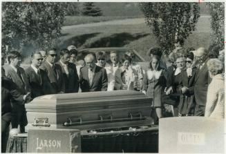 The first of many burials of flood victims takes place in Rapid City, S