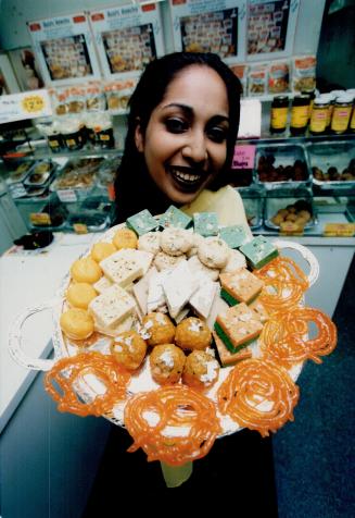 Sweet talk: Neha Bhagat of Surati Sweet Mart holds goodies traditionally given as gifts during Diwali